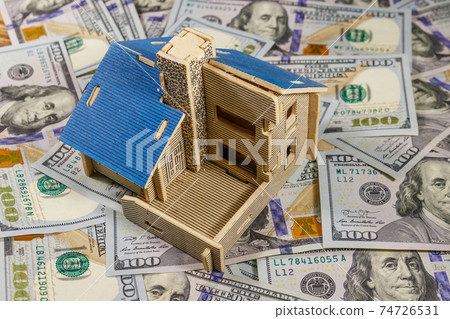 House model on background of U.S. one hundred dollar bills. Property investment, home loan, house mortgage, real estate concept 74726531