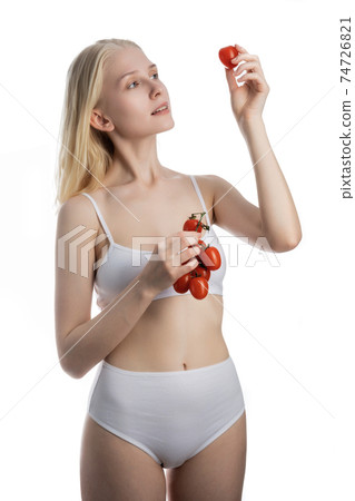 beautiful Young Woman Eating Tomatoes 74726821