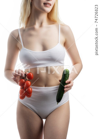 lady holding tomato and cucumber 74726823