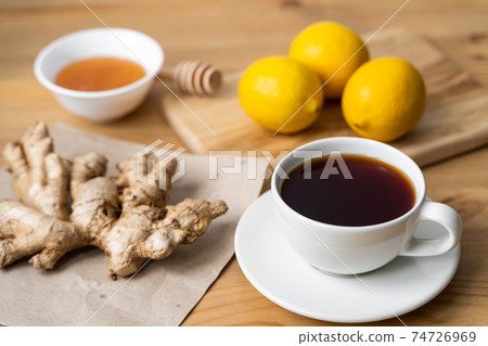 Cup of ginger tea with lemon on wooden table Cup of ginger tea with lemon on wooden table 74726969