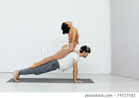 Man and woman paired family yoga asana gymnastics fitness 74727581