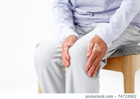 Senior woman suffering from knee osteoarthritis without face 74728902