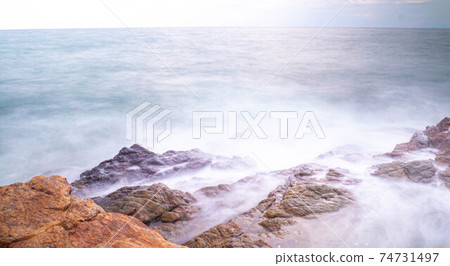 Long Exposure of Sea with Smooth Wave and Rock. Nature of Seascape abstract vacation travel in summer time. 74731497