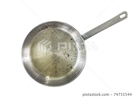 Skillet after used, isolated modern stainless steel skillet or pan with burning mark, used cooking oil in pan and burning small pieces of food. Isolated image on white background. Top view burned pan. 74731544