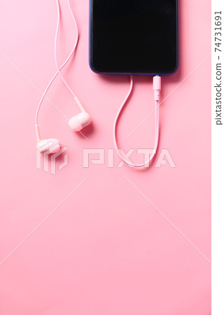 smart phone and headphone on pink background . smart phone and headphone on pink background . 74731691