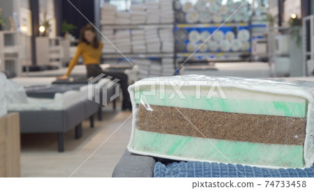 Unrecognizable woman shopping for new mattress at furniture store Unrecognizable woman shopping for new mattress at furniture store 74733458