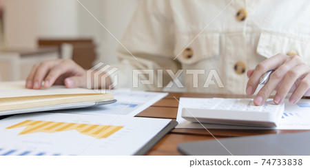 Head of accounting is recording the company's financial growth statistics using graphs as a reference for reviewing and analyzing the results, Taking notes and analyzing data graphs in office. Head of accounting is recording the company's financial growth statistics using graphs as a reference for reviewing and analyzing the results, Taking notes and analyzing data graphs in office. 74733838