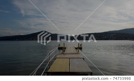 View of pier over sea against sky during summer day. 74733998