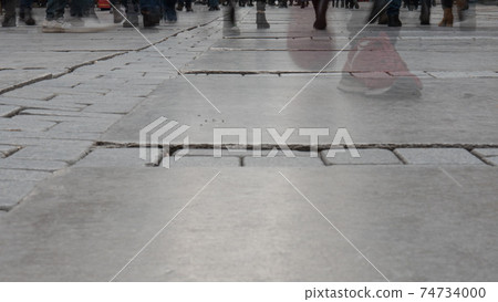 People feet walking on crowd city street. Pedestrians at the izmir city, Turkey. Motion blur. 74734000