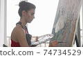 Young elegant woman painting at her workshop 74734529