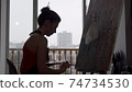 Silhouette of a female painter working at her studio 74734530