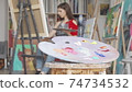 Selective focus on a palette at art studio of a young female artist 74734532