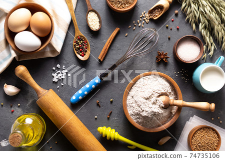 Bakery ingredients for homemade bread baking on table Bakery ingredients for homemade bread baking on table 74735106