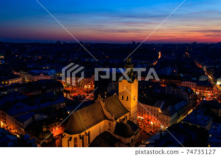 Aerial night view of illuminated Latin cathedral and Rynok square in Lviv, Ukraine. View from Lviv town hall 74735127