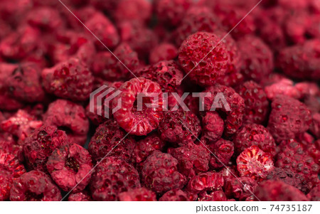 Heap of freeze dried raspberries close-up or dehydrated food background Heap of freeze dried raspberries close-up or dehydrated food background 74735187