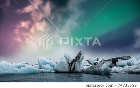 Northern lights aurora borealis over Jokulsarlon glacier ice lagoon in Iceland 74735559