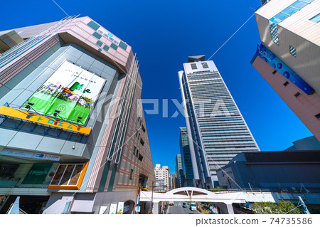 在藍天下閃閃發光的文京區役所和東京地鐵後樂園站等日本東京的城市景觀 74735586