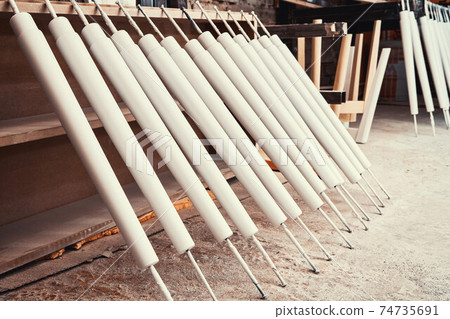 Set of wooden furniture legs drying after applying paint Set of wooden furniture legs drying after applying paint 74735691