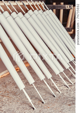 Set of wooden furniture legs drying after applying paint Set of wooden furniture legs drying after applying paint 74735692