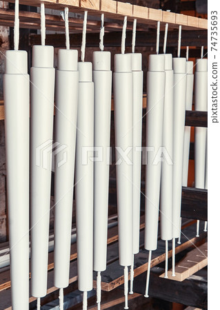 Set of wooden furniture legs drying after applying paint 74735693
