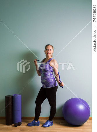 Woman stand with quipment for fitness and myofascial release 74736082