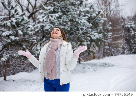 the woman enjoys a walk in the winter park 74736149