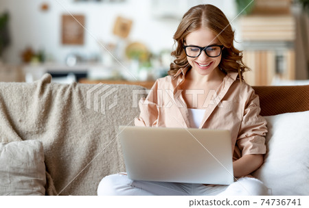 Content young woman having video call on laptop Content young woman having video call on laptop 74736741
