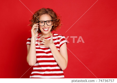 Surprised woman speaking on smartphone 74736757