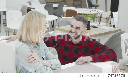 Young couple shopping for new furniture together at department store Young couple shopping for new furniture together at department store 74737576