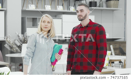 Young couple looking around at furnishings store Young couple looking around at furnishings store 74737585