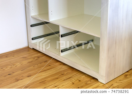 Close up of installation of wooden drawer in contemporary cupboard cabinet. Close up of installation of wooden drawer in contemporary cupboard cabinet. 74738291