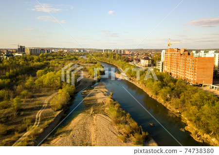Aerial view of tall residential apartment buildings under construction and Bystrytsia river in Ivano-Frankivsk city, Ukraine. Aerial view of tall residential apartment buildings under construction and Bystrytsia river in Ivano-Frankivsk city, Ukraine. 74738380