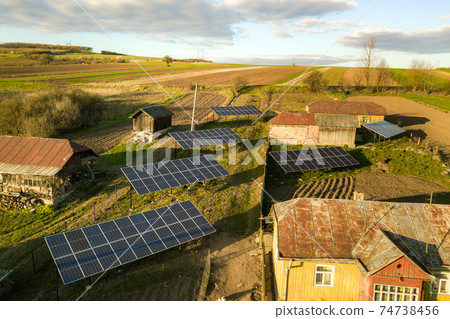 Aerial top down view of solar panels in green rural village yard. Aerial top down view of solar panels in green rural village yard. 74738456