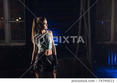 Young girl stands in an atmospheric gym. Sport Young girl stands in an atmospheric gym. Sport 74740013