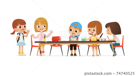 New pupil greeting classmates sitting at table. Boys and Girls draw picture with watercolor and pencils. Drawing activity in the art class. Boy and Girl Draw Pictures with paints and pencils 74740525