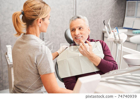 Man enjoying of his beautiful toothy smile Man enjoying of his beautiful toothy smile 74740939