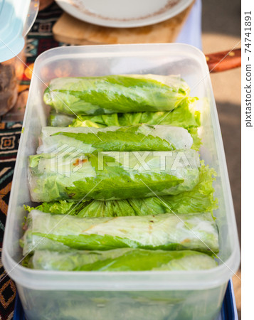 Fresh spring rolls with marijuana leaf. 74741891
