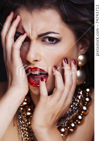beauty rich brunette woman with a lot of jewellery, hispanic curly lady posing very emotional 74743713