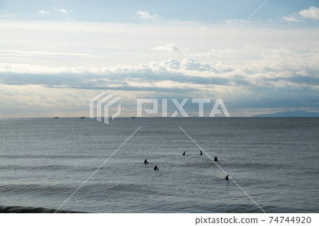 Surfers heading offshore 74744920