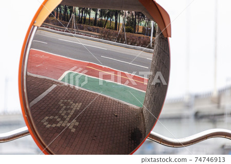 Curved mirror and sidewalk bicycle mark 74746913