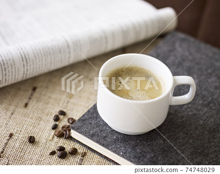 cup of coffee and open book 74748029