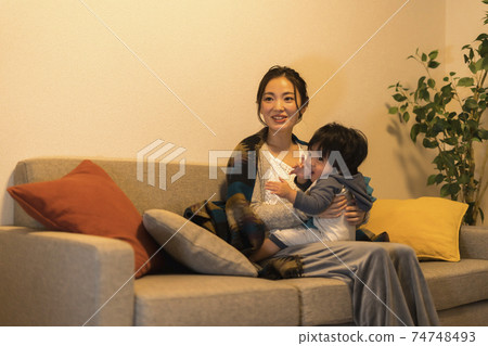 Young mother relaxing with her 11-month-old son 74748493