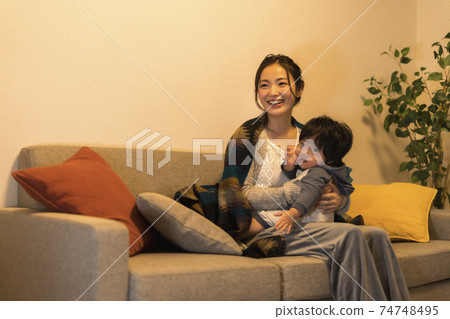 Young mother relaxing with her 11-month-old son 74748495