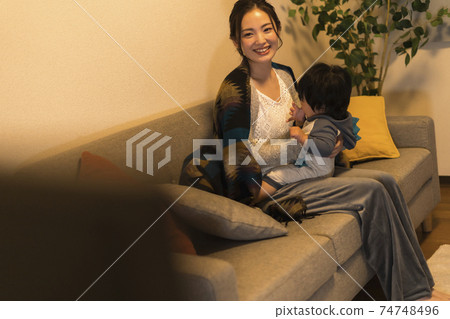 Young mother relaxing with her 11-month-old son 74748496