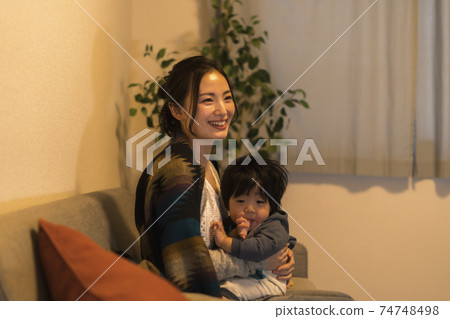 Young mother relaxing with her 11-month-old son Young mother relaxing with her 11-month-old son 74748498