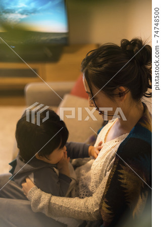 Young mother relaxing with her 11-month-old son 74748500