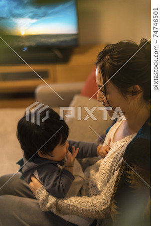 Young mother relaxing with her 11-month-old son 74748501
