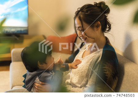 Young mother relaxing with her 11-month-old son 74748503