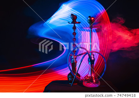 smoky Turkish hookahs with coals on bowls and water in flasks smoky Turkish hookahs with coals on bowls and water in flasks 74749418