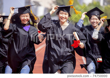 happy graduation students running on the school 74750000